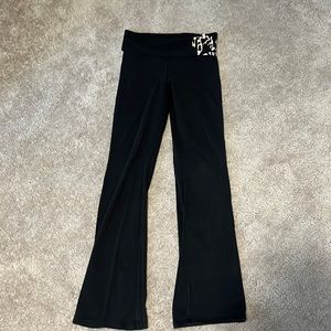 PINK yoga pants with PINK cheetah lettering around left hip